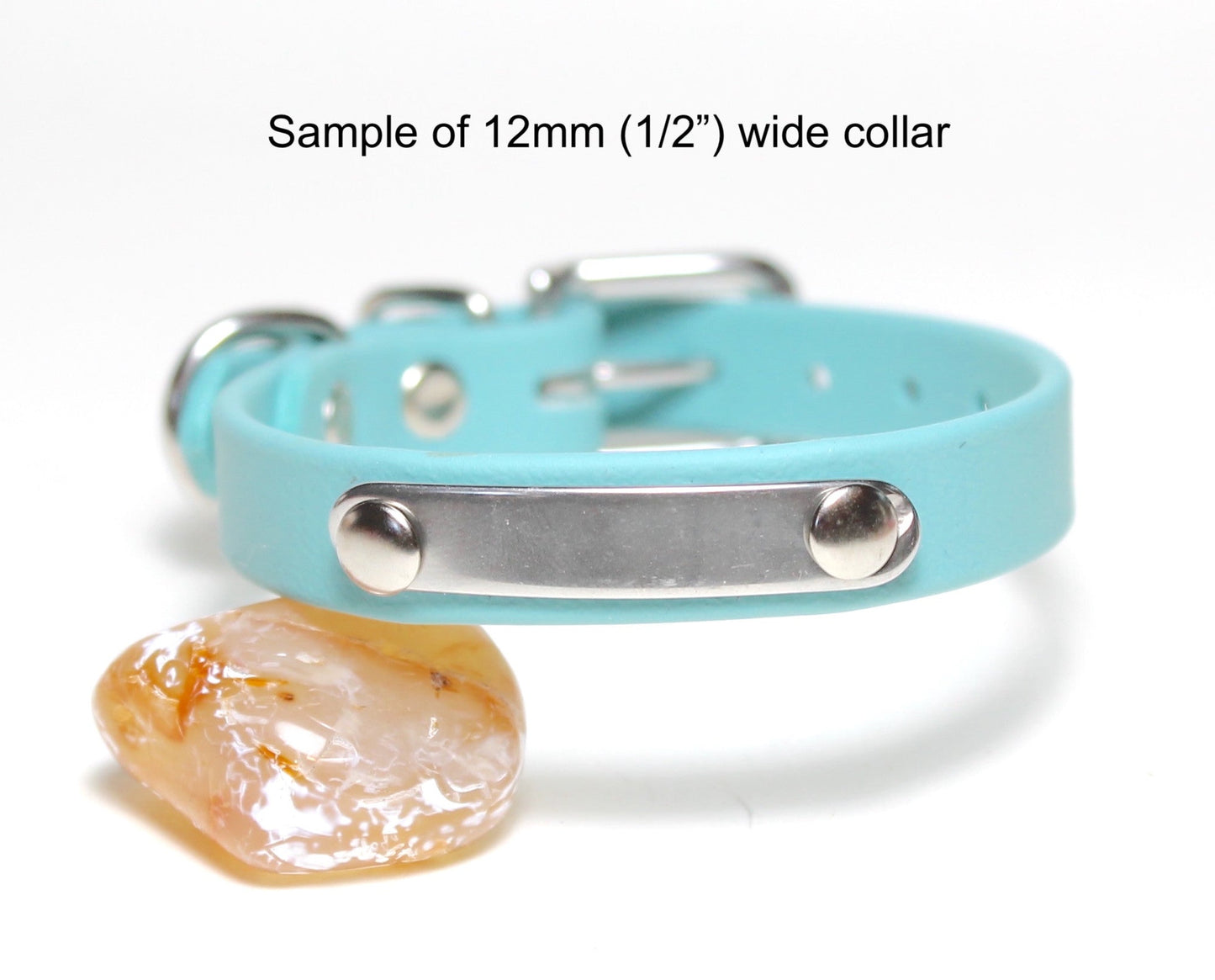 A turquoise blue pet collar with a silver metal ID plate and adjustment rings, shown on a white background with a small decorative stone prop. Text on the image reads 'Sample of 12mm (1/2") wide collar'.