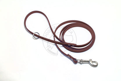 Extra thin brown faux leather dog leash with metal clip on a white background