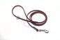Extra thin brown faux leather dog leash with metal clip on a white background